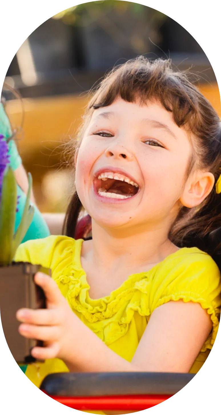 A girl smiling in Early Childhood Intervention Program